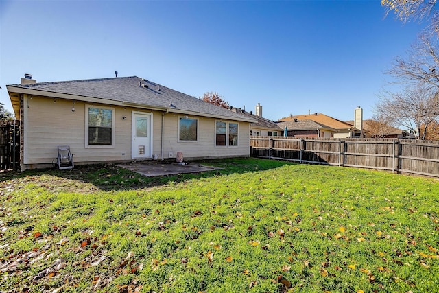 rear view of house with a patio area and a lawn