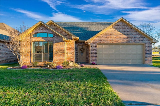 view of front of property with a garage and a front lawn