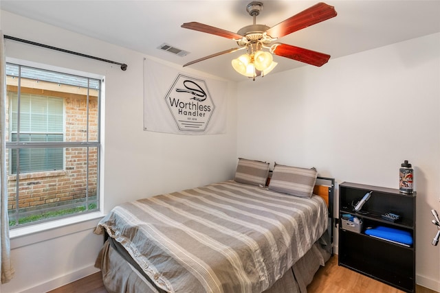 bedroom with hardwood / wood-style flooring and ceiling fan