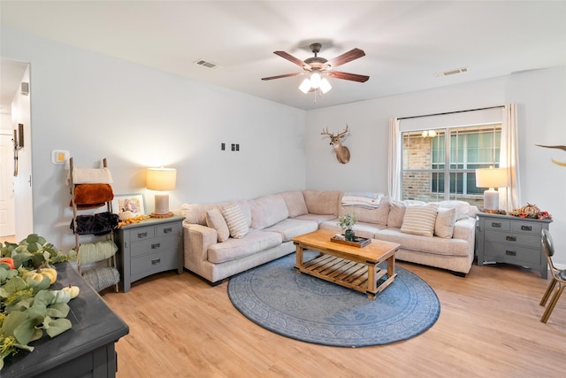 living room featuring light hardwood / wood-style floors and ceiling fan