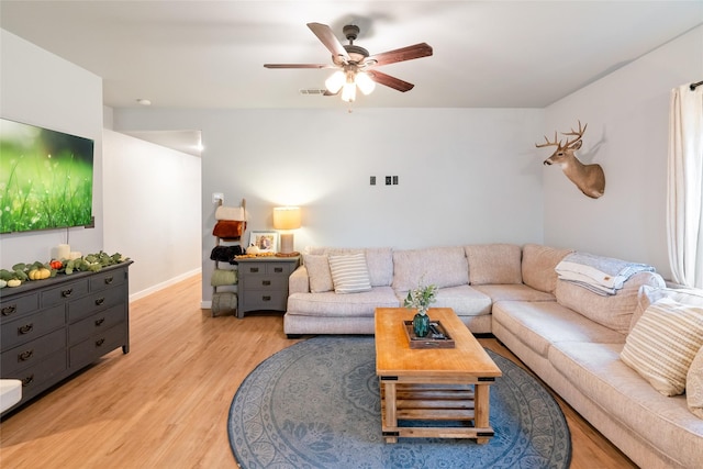 living room with ceiling fan and light hardwood / wood-style flooring