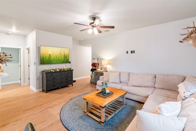 living room featuring ceiling fan and wood-type flooring