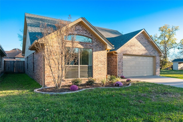 view of front of house with a front yard and a garage