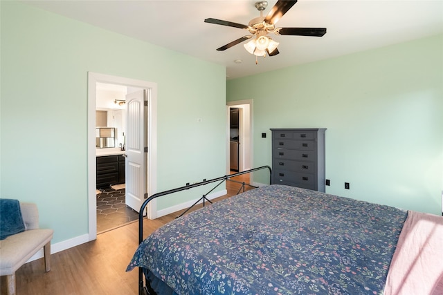 bedroom featuring ensuite bathroom, ceiling fan, and wood-type flooring