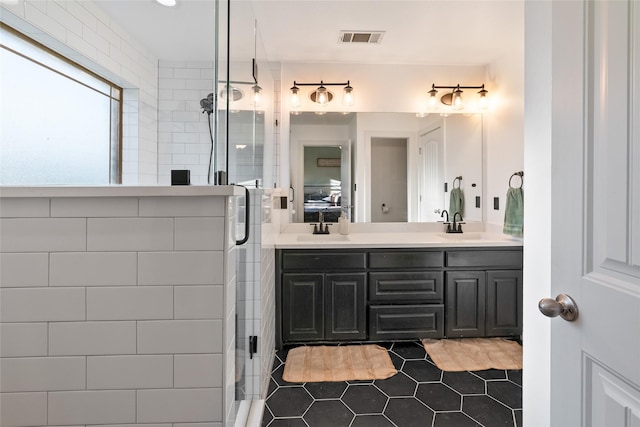 bathroom with tile patterned flooring, vanity, and walk in shower