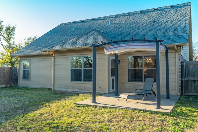 rear view of house with a patio and a lawn