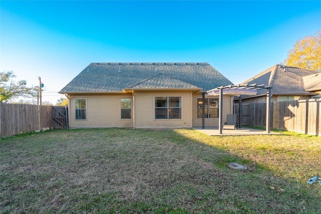 rear view of house featuring a patio area and a yard