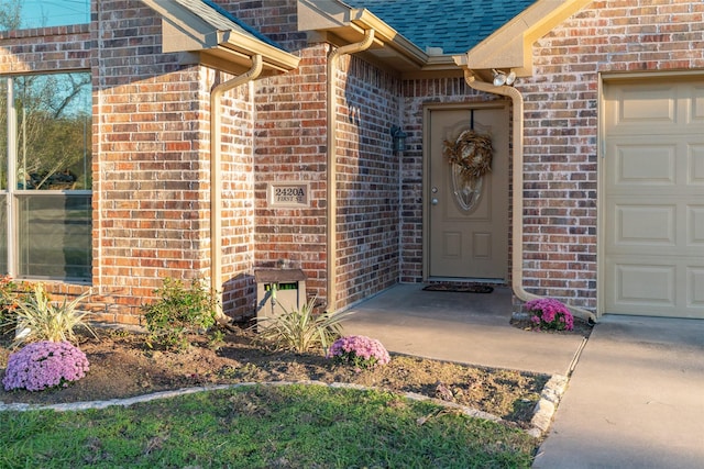 doorway to property with a garage