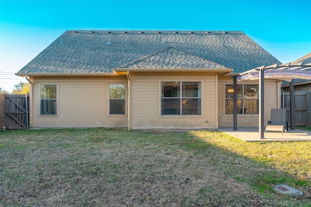 back of house with a pergola, a yard, and a patio