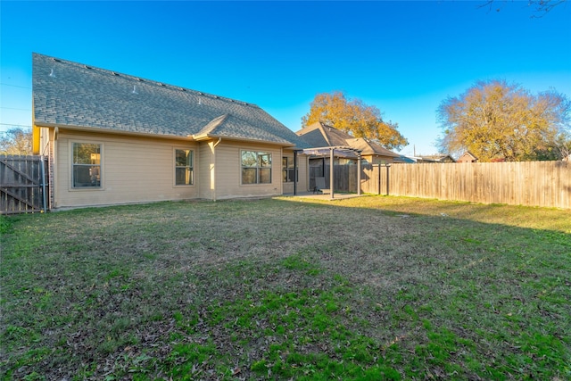 rear view of house featuring a lawn