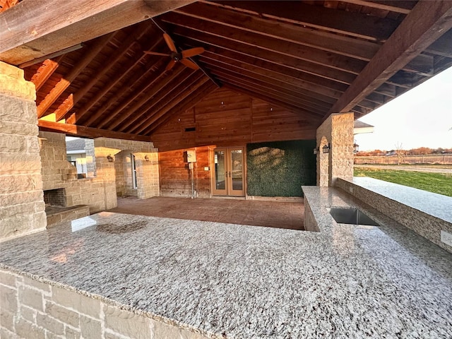 view of patio with an outdoor stone fireplace