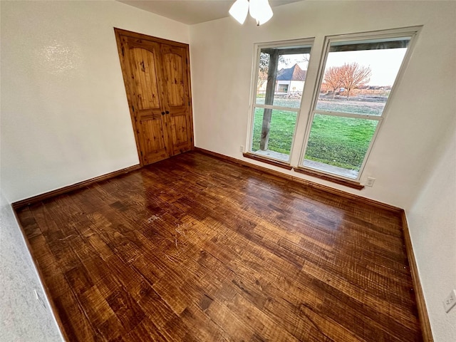 unfurnished room featuring dark hardwood / wood-style flooring