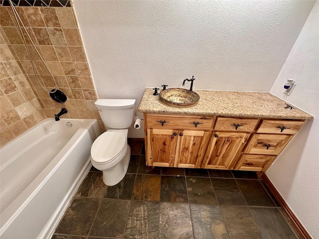 full bathroom with vanity, tiled shower / bath, and toilet