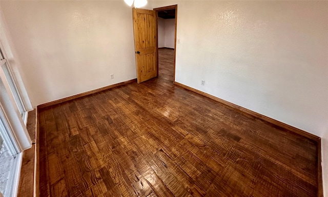 spare room with wood-type flooring