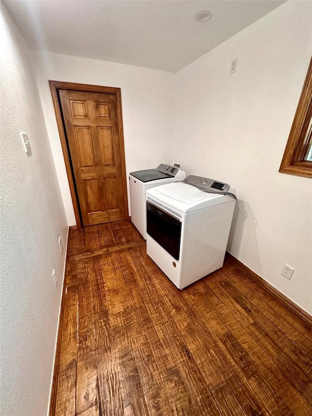 laundry room with washing machine and dryer and dark hardwood / wood-style floors