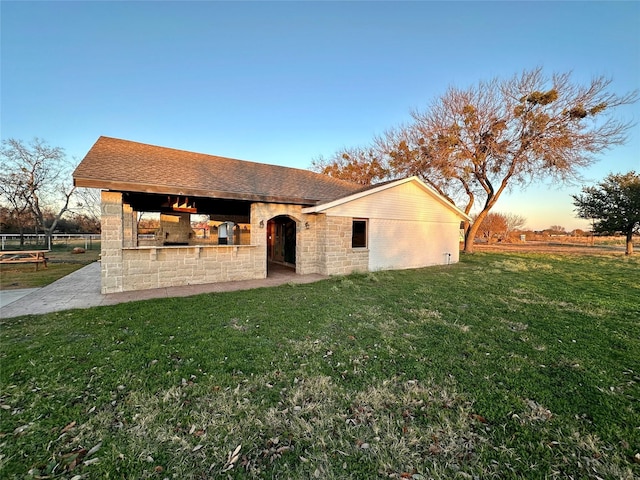 back house at dusk with a yard