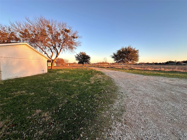 yard at dusk with a rural view