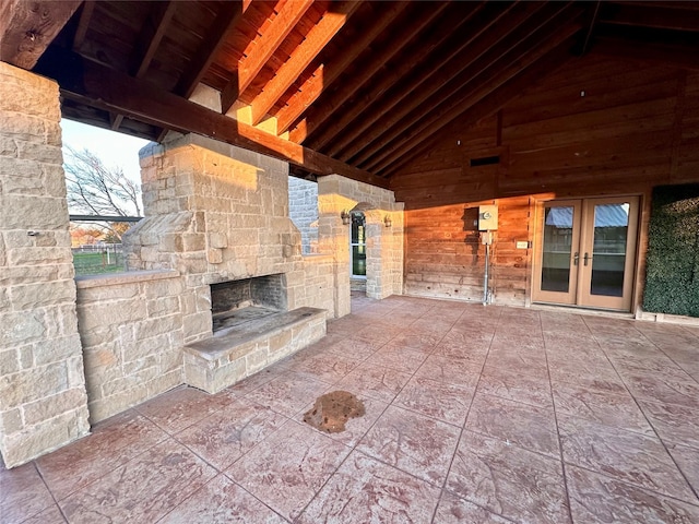 view of patio / terrace with an outdoor stone fireplace and french doors