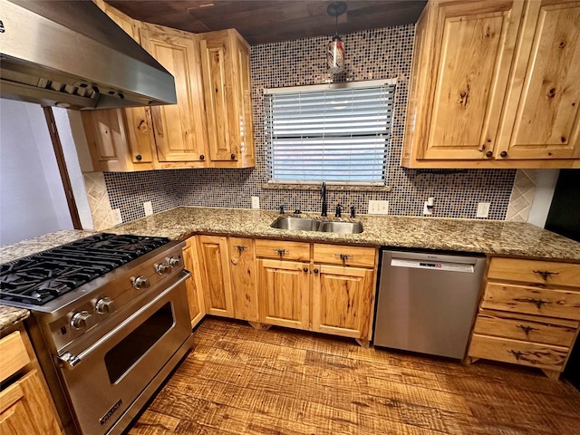 kitchen featuring pendant lighting, sink, appliances with stainless steel finishes, light stone counters, and extractor fan