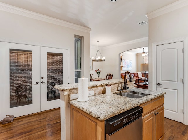 kitchen featuring sink, french doors, dark wood-type flooring, stainless steel dishwasher, and a kitchen island with sink