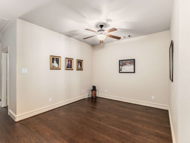 spare room featuring dark hardwood / wood-style floors and ceiling fan