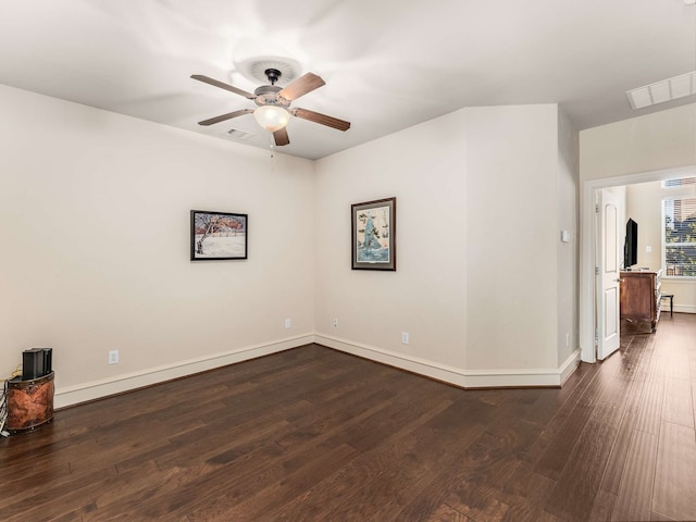 unfurnished room with dark hardwood / wood-style floors and ceiling fan