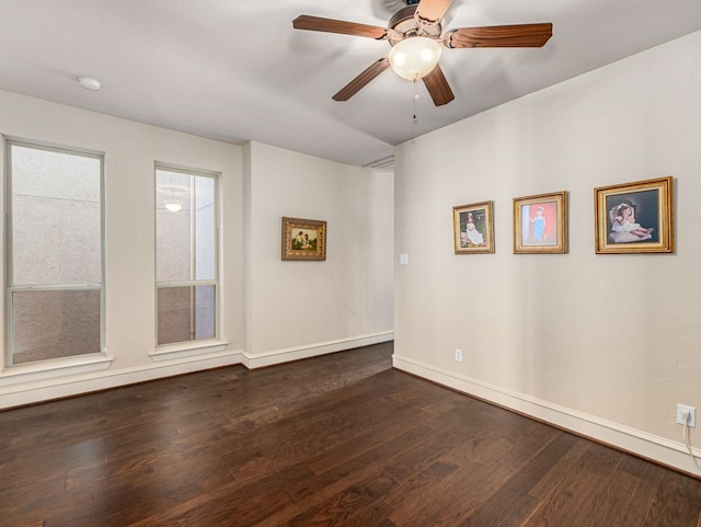 spare room featuring ceiling fan and dark wood-type flooring