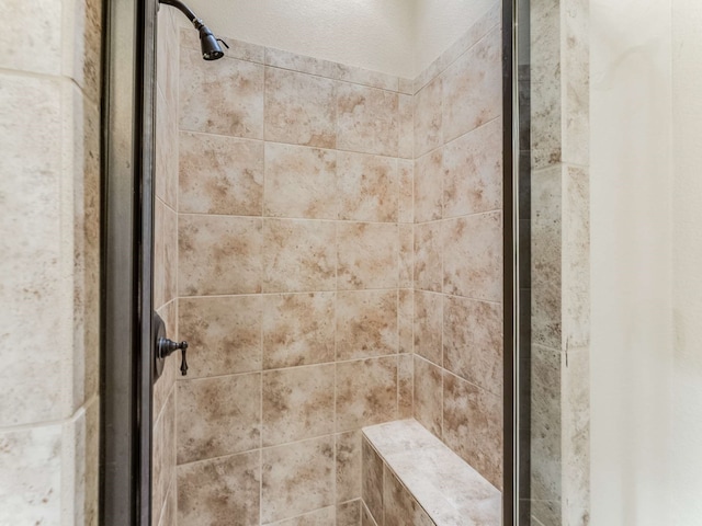 bathroom with tiled shower