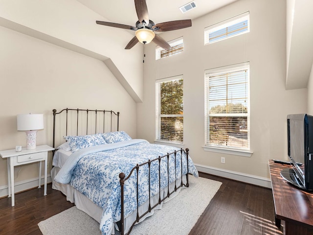 bedroom with dark hardwood / wood-style flooring and ceiling fan