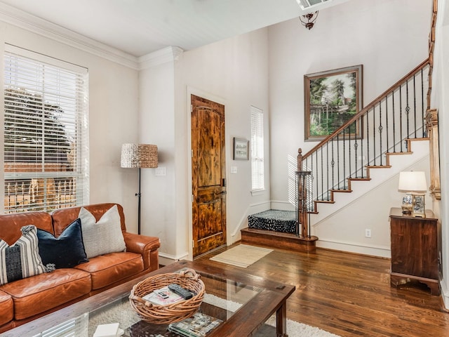 living room featuring dark hardwood / wood-style flooring, crown molding, and a wealth of natural light