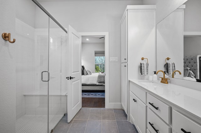 bathroom featuring tile patterned flooring, vanity, and an enclosed shower