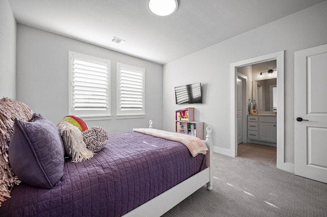 bedroom with carpet flooring and ensuite bath