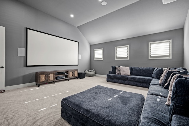 carpeted home theater room with lofted ceiling