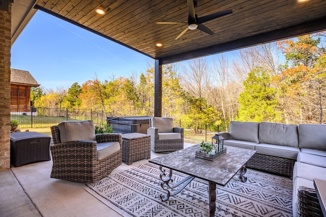 view of patio with outdoor lounge area, a hot tub, and ceiling fan