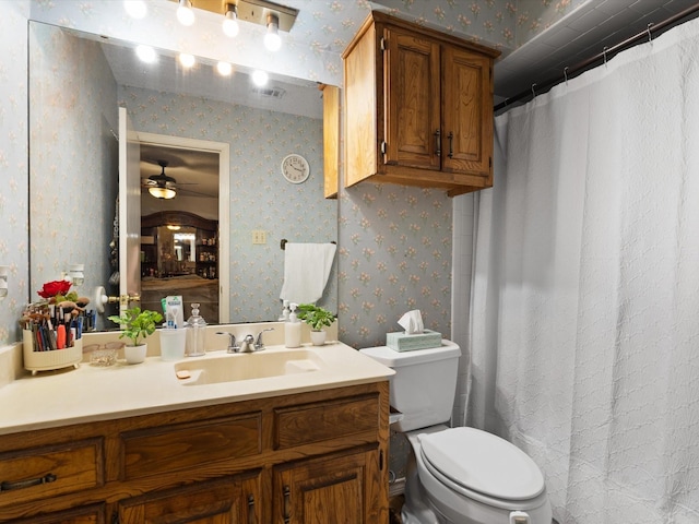 bathroom with vanity, toilet, and ceiling fan