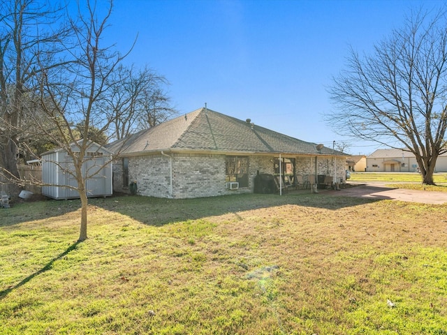 view of home's exterior with a storage unit and a lawn