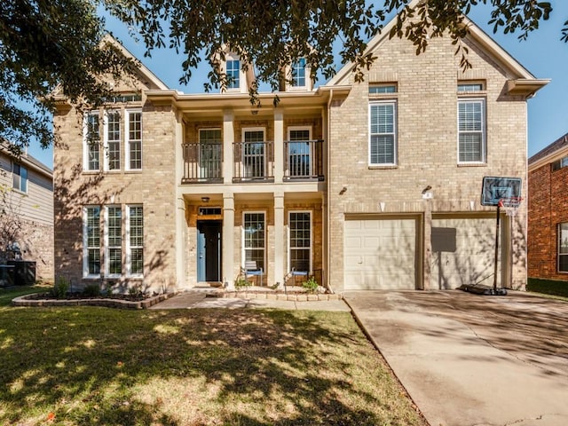 view of front of house featuring a garage, a balcony, and a front lawn