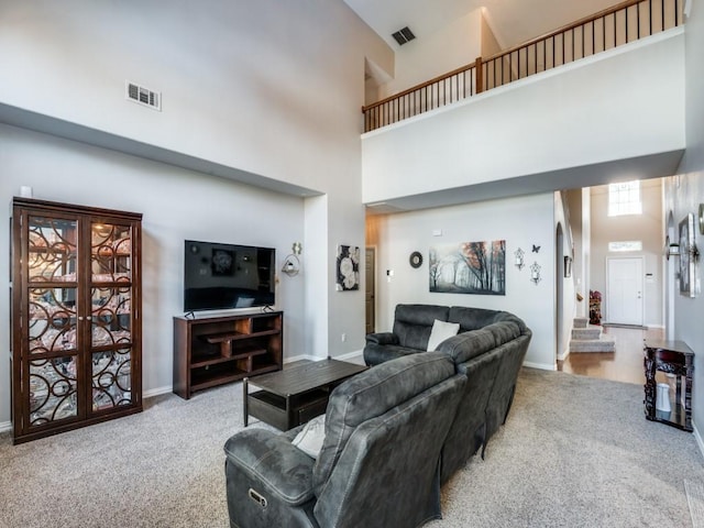 carpeted living room featuring french doors and a high ceiling