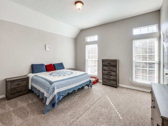 bedroom featuring light carpet and vaulted ceiling