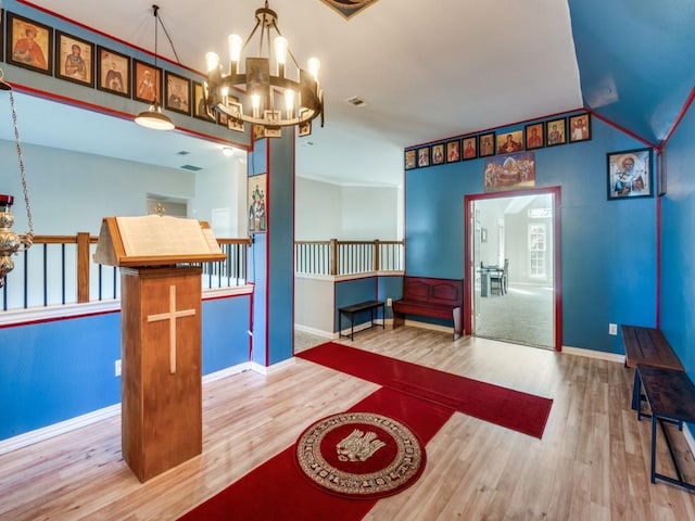 interior space featuring hardwood / wood-style floors and a notable chandelier