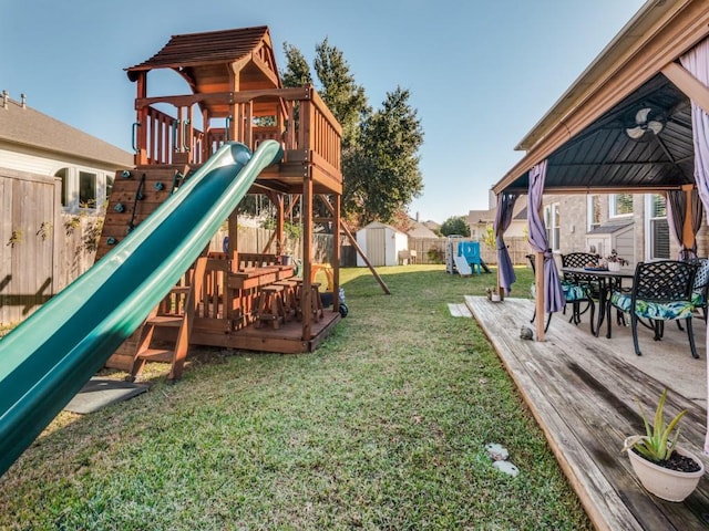 view of jungle gym featuring a gazebo, a yard, and a shed