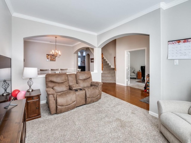 carpeted living room with crown molding and a notable chandelier