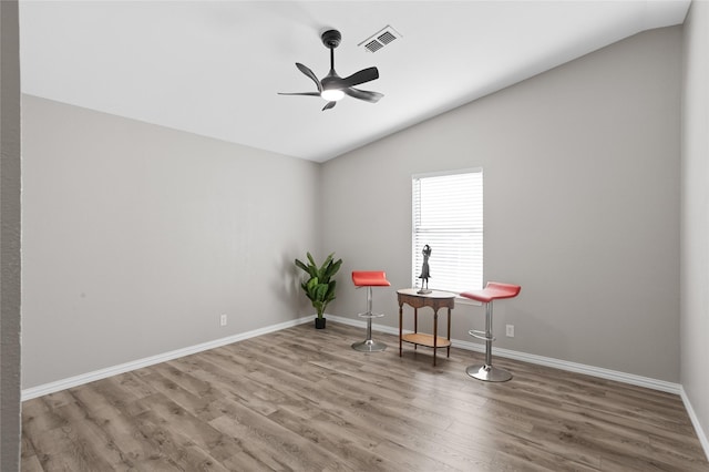 interior space with hardwood / wood-style flooring, ceiling fan, and vaulted ceiling