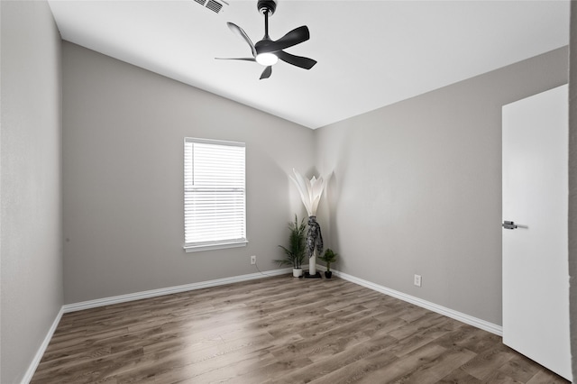 unfurnished room with ceiling fan, dark wood-type flooring, and lofted ceiling