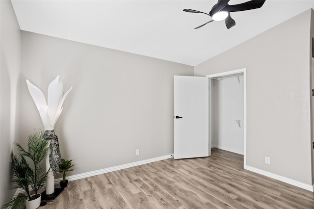 unfurnished bedroom featuring a closet, vaulted ceiling, ceiling fan, and light hardwood / wood-style floors