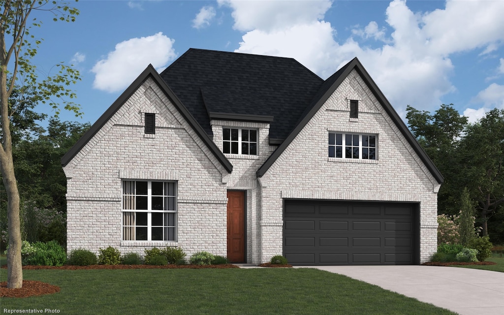 view of front of home featuring a garage and a front yard