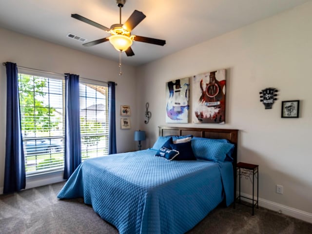 bedroom with ceiling fan and dark carpet