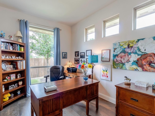 home office featuring a wealth of natural light and dark hardwood / wood-style floors