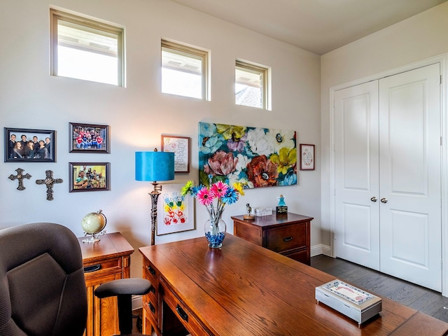 office space with dark hardwood / wood-style floors and a healthy amount of sunlight