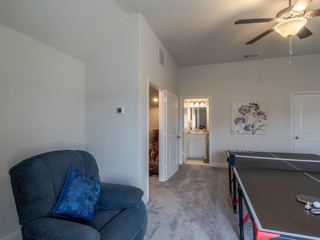 recreation room with ceiling fan and carpet